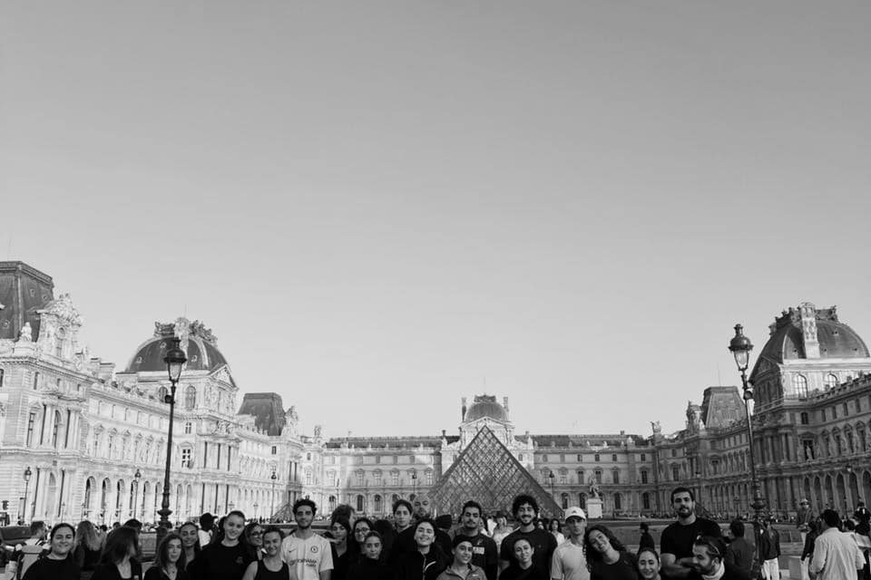 Run Club Beirut members gathered together in Paris, in club shirts, on a run away from home