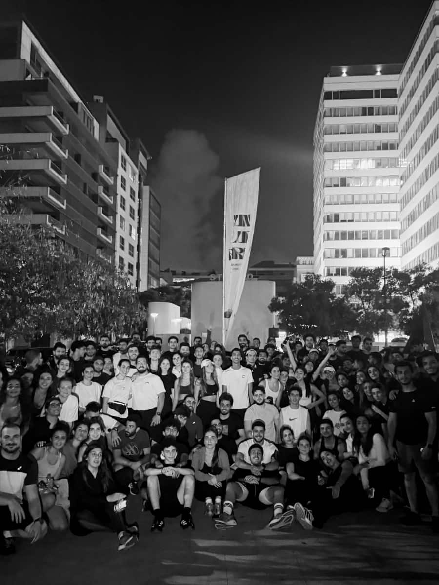 The full Run Club Beirut community together at night in the middle of the city