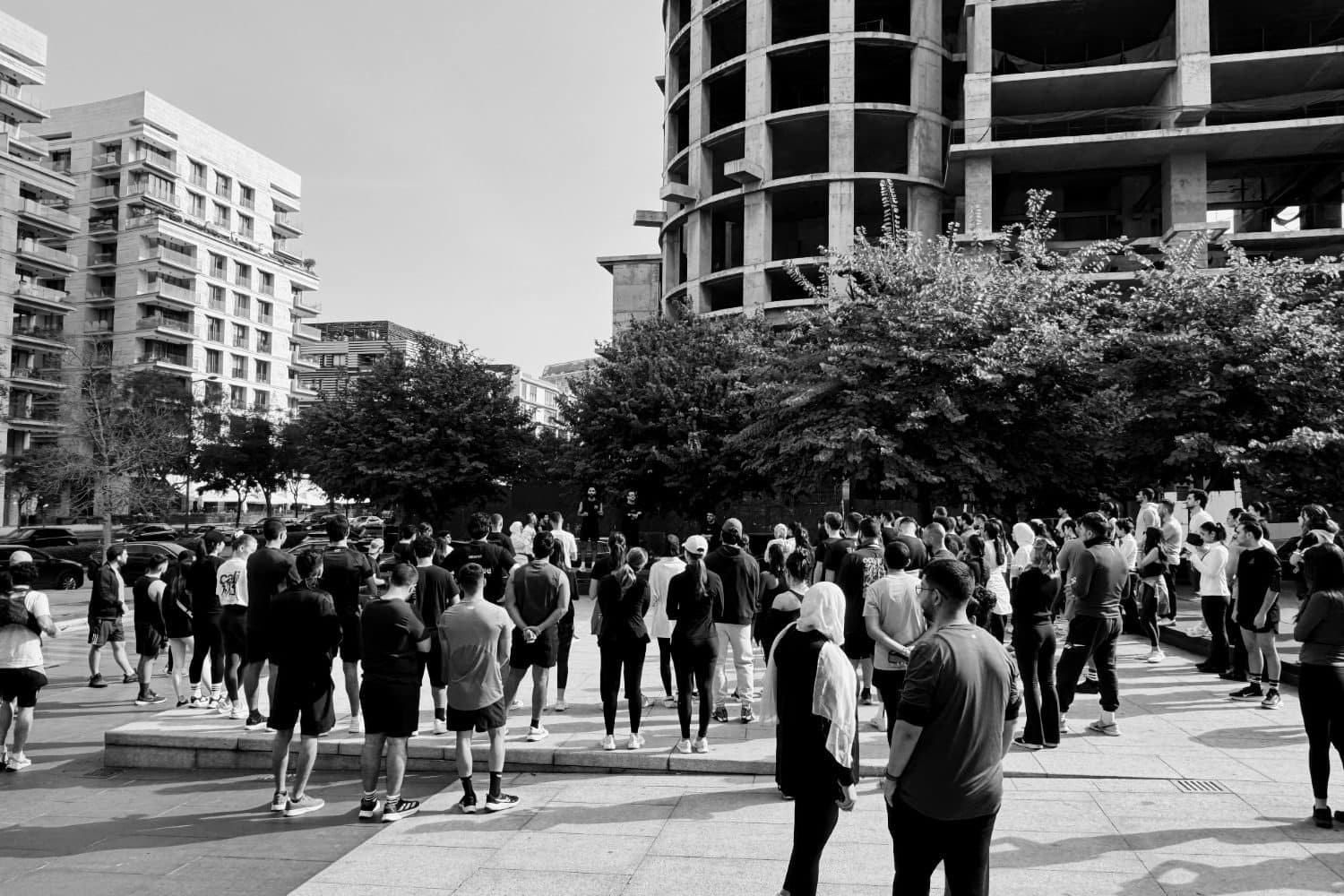 A dense crowd of runners gathered between Downtown Beirut towers before setting off