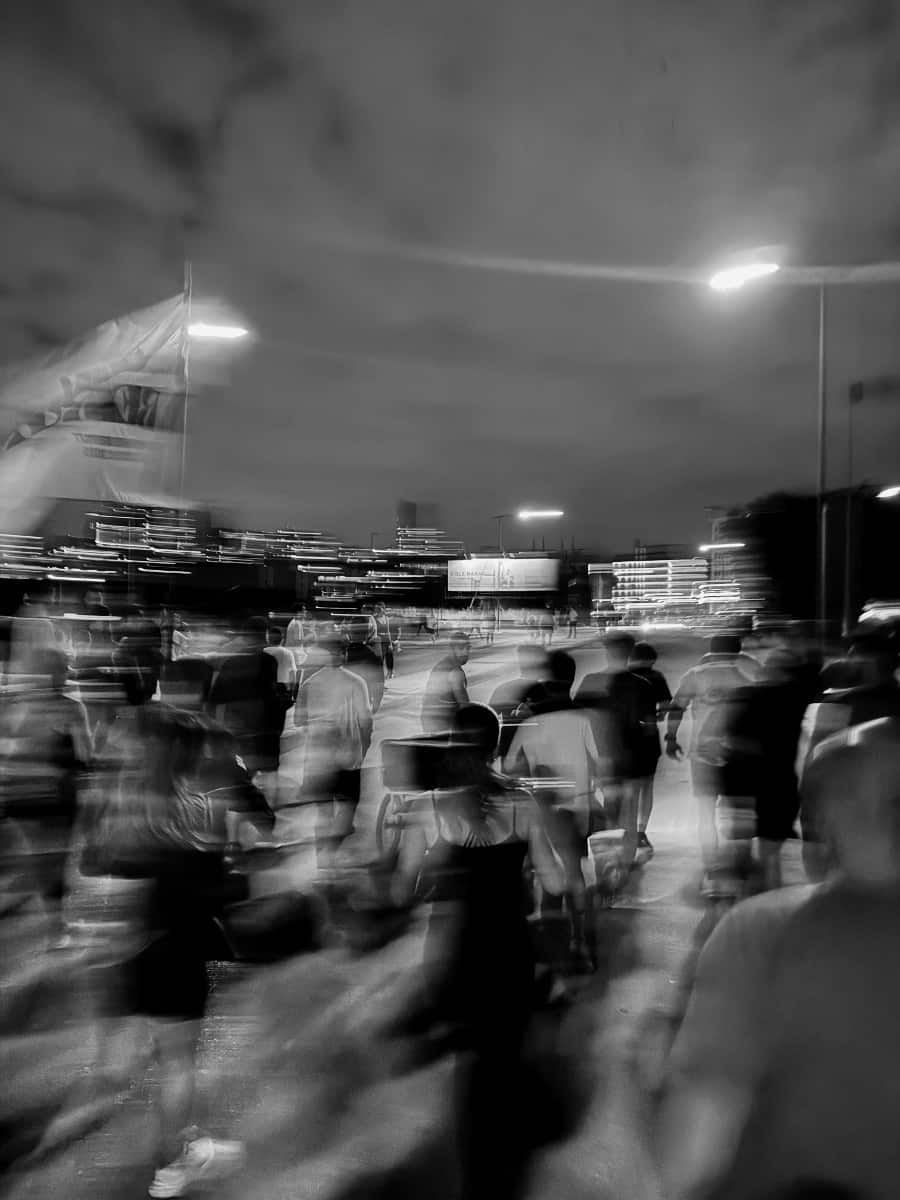 A long-exposure frame of the Run Club Beirut pack streaming through the city at night under streetlights